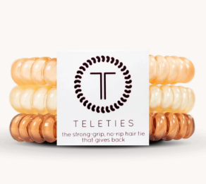 Stack of hair ties with a Teleties branded card on a white background