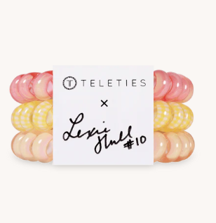 Set of colorful hair ties with a label on a white background