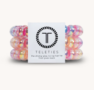 Set of colorful hair ties with a Teleties branded card on a white background