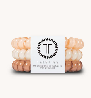 Stack of pink and white hair ties with Teleties branding on a white background