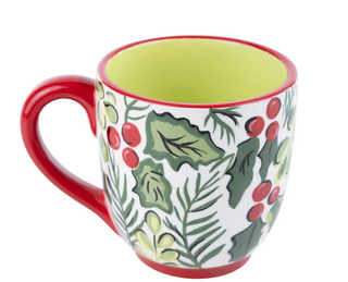 Decorative mug with holly design on a white background