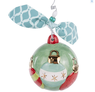 Decorative ornament with a green ball, red accents, and gold details on a white background