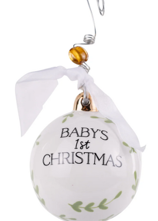 Decorative ornament for 'Baby's 1st Christmas' with a white ribbon and leaf patterns on a white background.