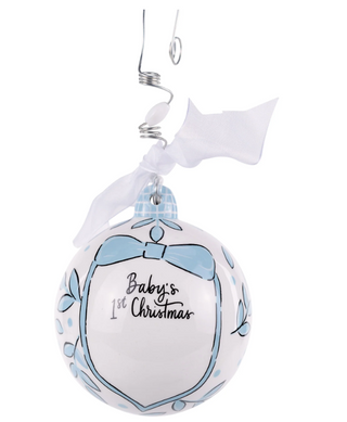 Decorative ornament for baby's first Christmas with blue bows and text on a white background