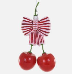 Decorative ornament shaped like a character with red and white striped dress and cherry-like base on a white background