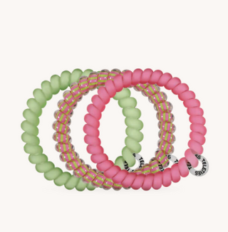 Set of pink and green beaded bracelets on a white background