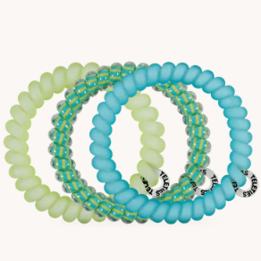 Set of blue and green beaded bracelets on a white background