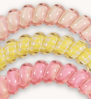 Close-up of pink and yellow glass beads on a white background