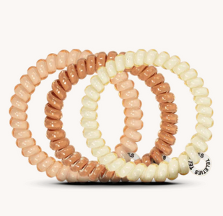 Set of three beaded bracelets in beige and brown on a white background