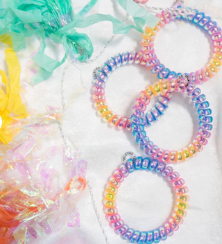 Colorful beaded bracelets on a white background with colorful yarn.