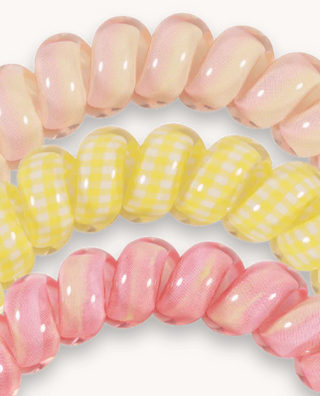 Close-up of pink and yellow beads on a white background
