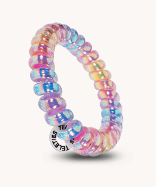 Multicolored beaded ring with a clear plastic band on a white background