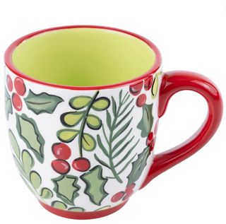 Decorative mug with holly design on a white background