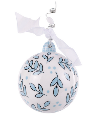 Decorative Christmas ball ornament with blue leaf patterns on a white background