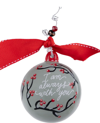 Decorative ornament with red ribbon and 'I am always with you' text on a white background