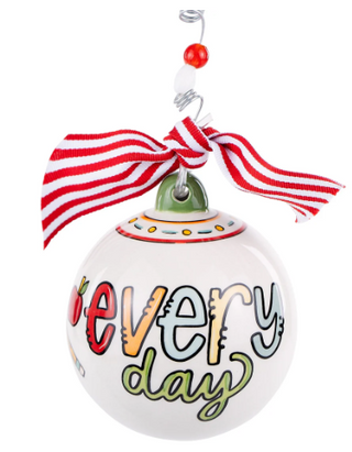 Decorative ornament with 'Every Day' text and red and white striped ribbon on a white background