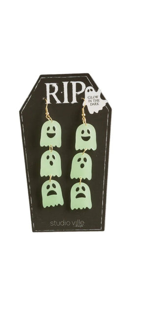 Glowing ghost-shaped earrings on a 'RIP' branded card.