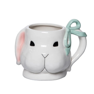 Ceramic mug shaped like a bunny face with a bow on a white background