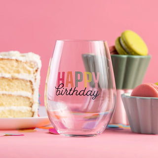 Clear glass with 'Happy Birthday' text on a pink background with cake and macarons.
