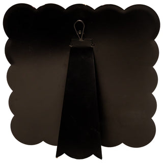 Black scalloped-edged board with a clip on a white background