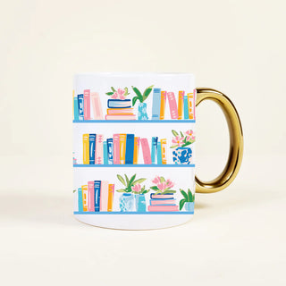 Mug with bookshelf design and gold handle on a light background