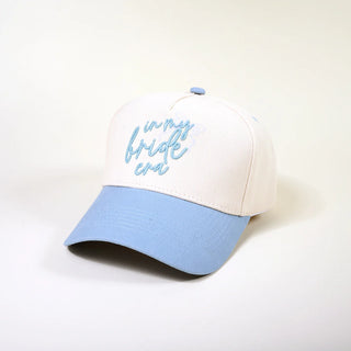 White and blue cap with 'in my bride era' text on a white background