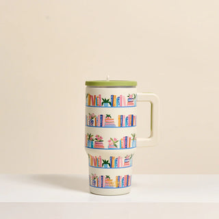 Travel mug with book-themed design on a beige background