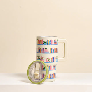 Mug with book-themed design on a beige background