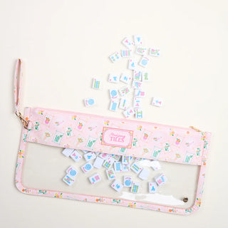 Set of colorful tiles with a pink carrying case on a white background