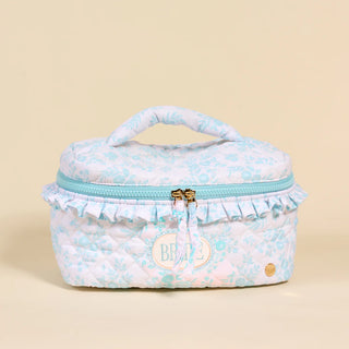 Floral patterned cosmetic bag with ruffled edges on a beige background