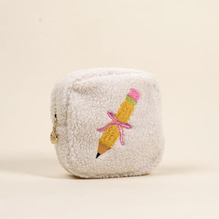 White plush pouch with a pencil design on a beige background