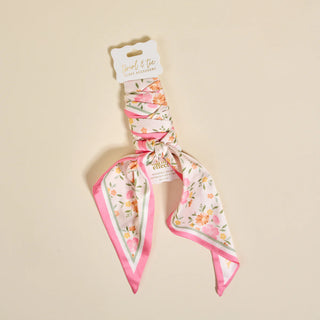 Floral scarf with pink border on beige background
