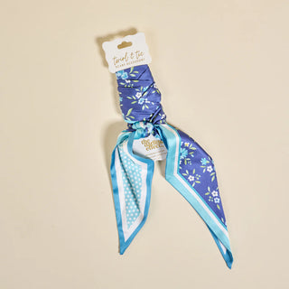 Blue floral patterned neck scarf on a beige background