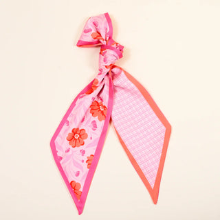 Pink floral and checkered scarf on a beige background