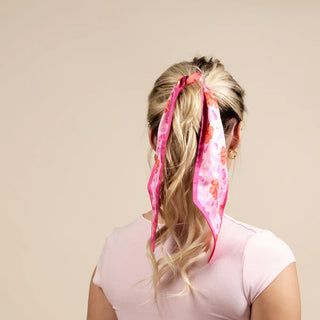 Person with floral headband on a plain background