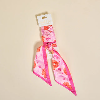 Pink floral headband on a beige background