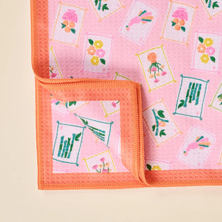 Pink fabric with floral and geometric patterns on a beige background