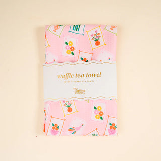Waffle tea towel with floral patterns on a pink background