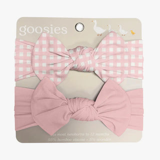 Set of pink checkered and solid bow headbands on a 'goosies' branded card.