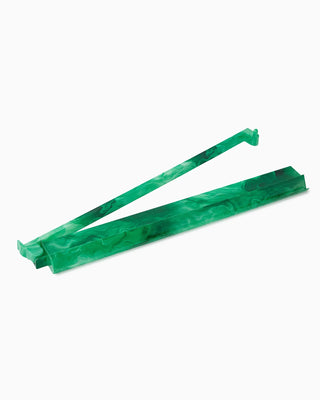 Two green rubber bands on a white background