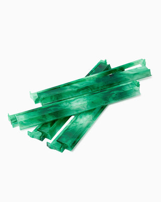 Green licorice sticks on a white background
