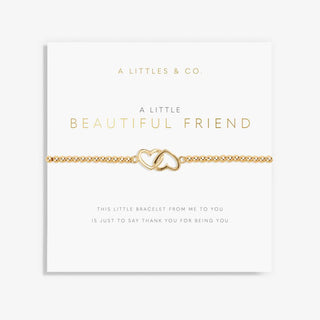 Gold bracelet with interlocking heart design on a 'A Littles & Co.' card.