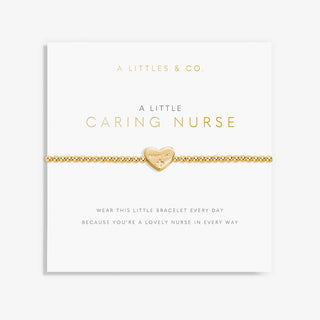 Gold bracelet with heart charm on a white card with text