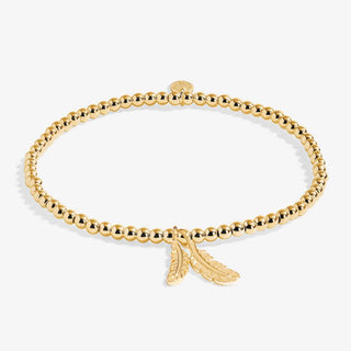Gold bracelet with a feather charm on a white background