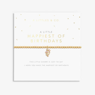 Gold bracelet with a pink charm on a white card with text