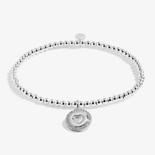 Silver beaded bracelet with a heart-shaped charm on a white background