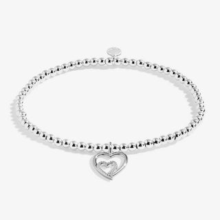 Silver bracelet with a heart-shaped charm on a white background
