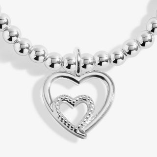 Silver bracelet with a heart-shaped clasp on a white background