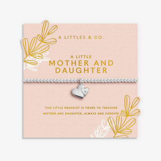 Silver bracelet with heart charm on a 'A Littles & Co.' branded card with decorative elements.