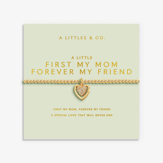 Gold heart-shaped pendant necklace on a light green card with text